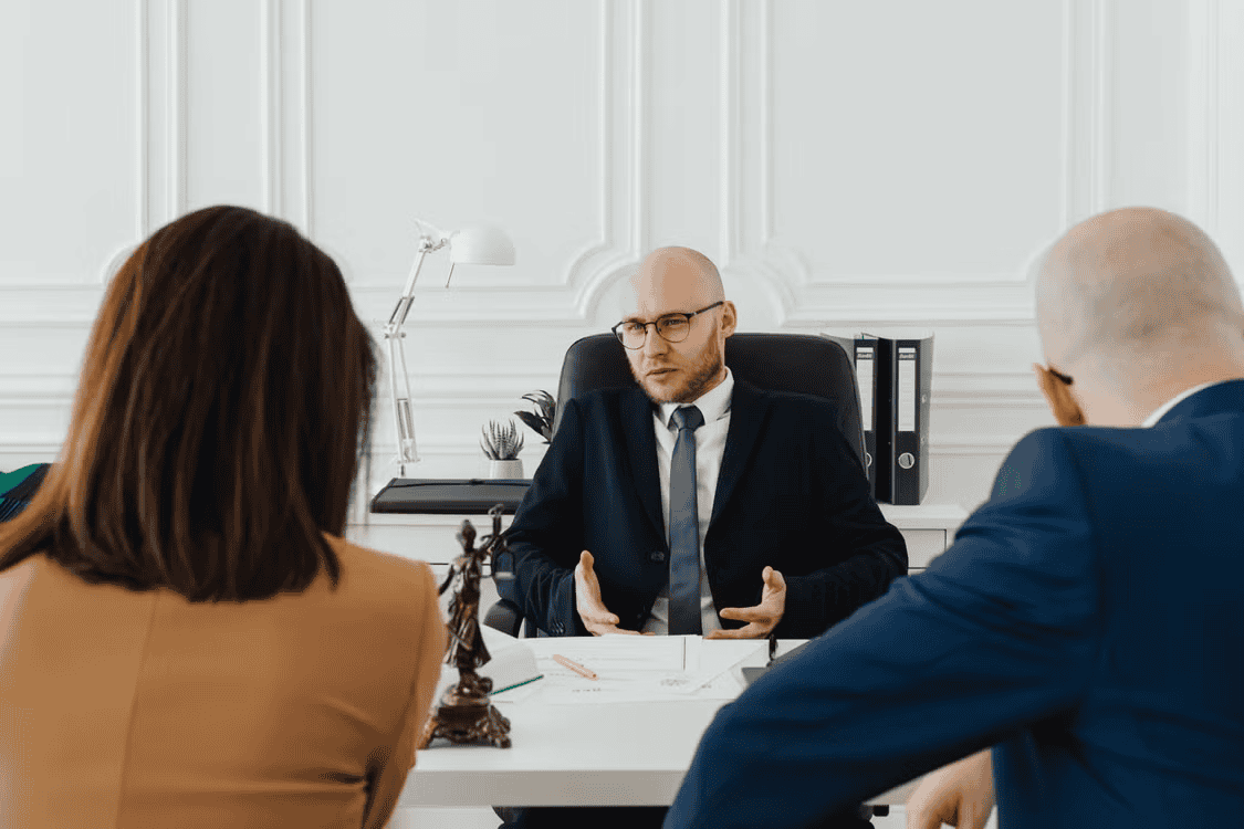 injury lawyer speaking with two people