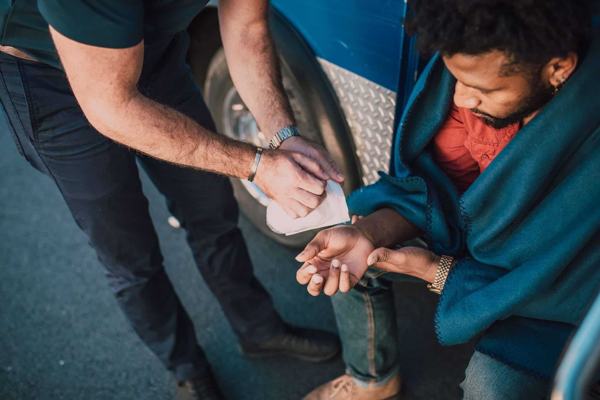 A paramedic is treating an injured man.