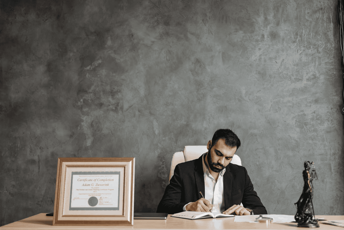lawyer sat at desk writing