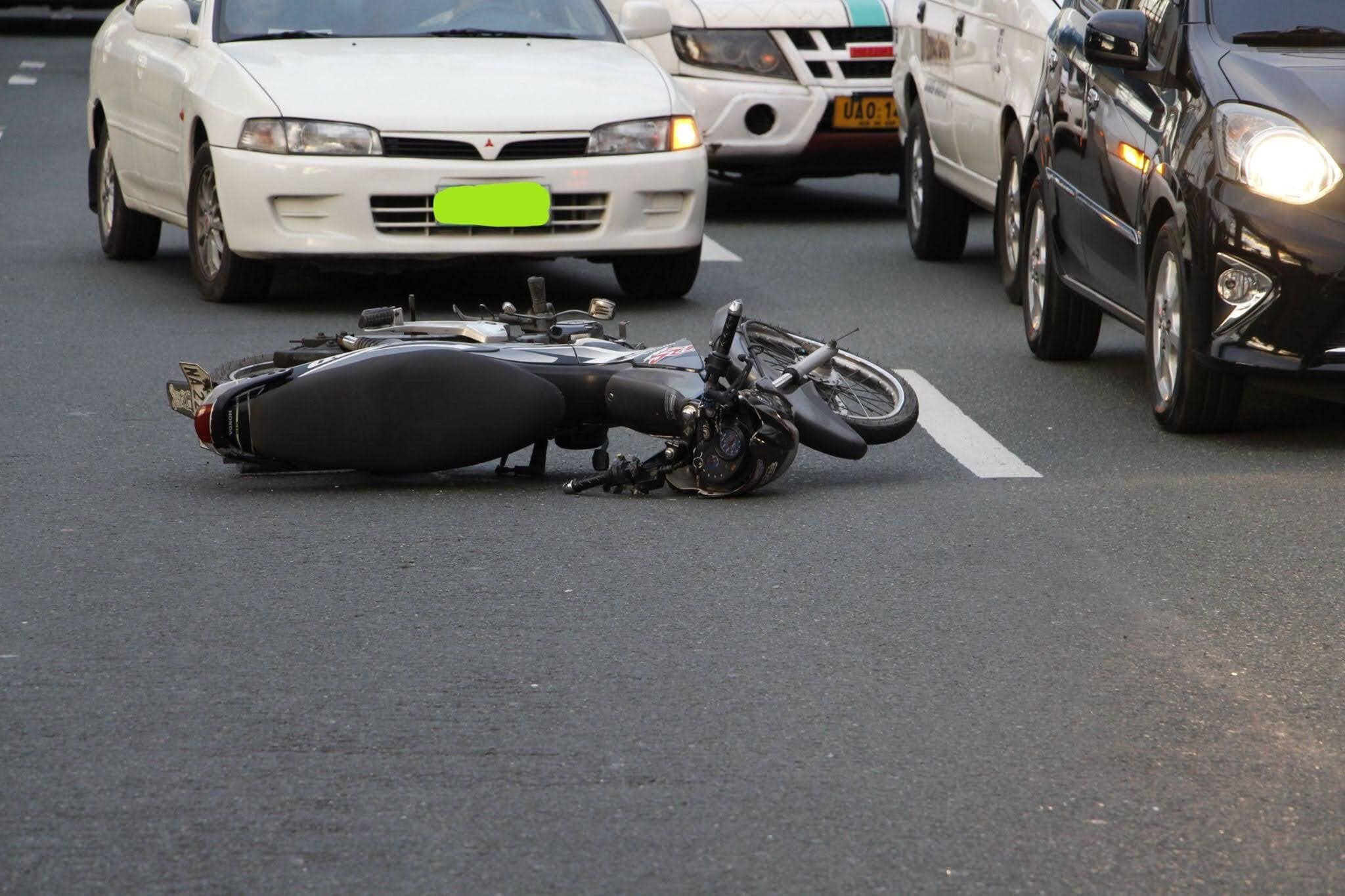 A motorcycle lies on the road after a collision.