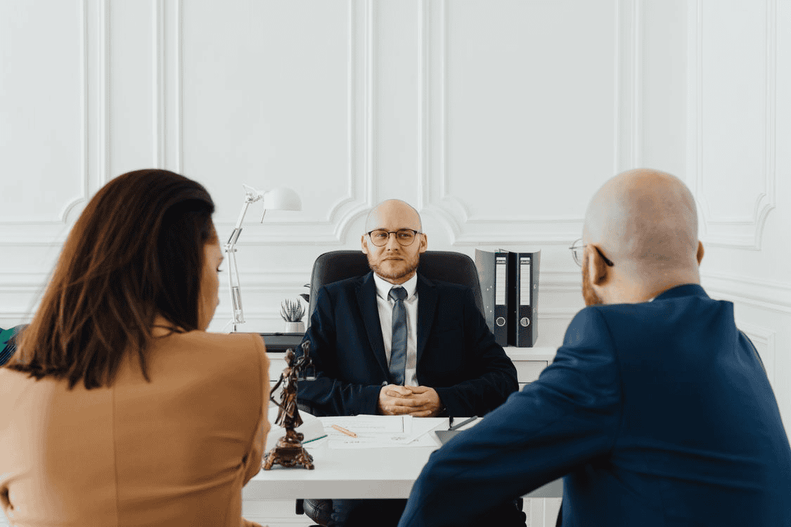 man and woman consulting with a lawyer